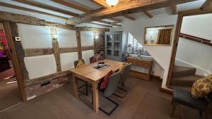 a dining room with a wooden table and chairs at Character 3-Bed Cottage Alton Towers Polars Peaks in Whiston