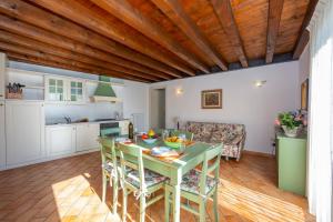 a kitchen and living room with a table and chairs at Orchidea in Hilly area - Happy Rentals in Gargnano