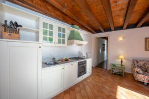 a kitchen with a sink and a stove top oven at Orchidea in Hilly area - Happy Rentals in Gargnano