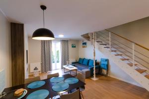 a living room with a blue couch and a staircase at Apartamenty, Domki i Pokoje ze śniadaniem Kajan in Jastrzębia Góra +288 photos