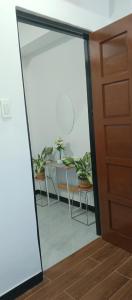 a glass door leading into a room with a table with potted plants at Kings'Palms Residence01 in General Santos