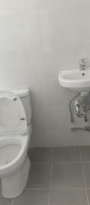 a white bathroom with a toilet and a sink at Kings'Palms Residence01 in General Santos