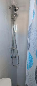 a bathroom with a shower with a toilet and a shower curtain at Kings'Palms Residence01 in General Santos