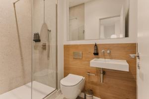 a bathroom with a shower and a toilet and a sink at The Marloes in London