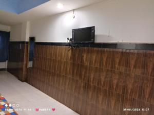 a flat screen tv on top of a wooden wall at Hotel Swagat Bhubaneswar in Bhubaneshwar