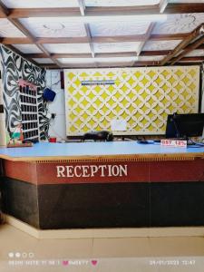 a reception desk with a boat in a room at Hotel Swagat Bhubaneswar in Bhubaneshwar