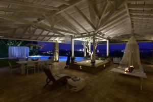 a pavilion with a view of the city at night at The Editor's Villa - Member of Spiritual Living Corfu in Virós