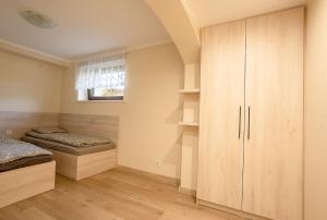 a bedroom with two beds and a window at Apartament Pod Malinka in Wisła