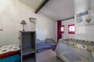 a small room with a bed and a couch at Maison Barcares fb 114 in Le Barcarès