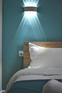 a bedroom with a bed with a light on the wall at Отель ЭРА in Almaty