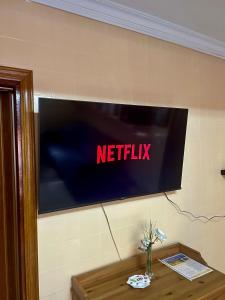 a tv on a wall with a netflix sign on it at Del Valle 1 in Cudillero