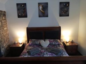 um quarto com uma cama com um coração em orchard meadow holiday barn leek-buxton-Ashbourne em Buxton