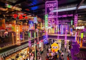 a crowd of people in a mall with neon signs at Sky View 2B1B@burwood in Sydney