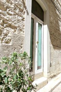 a door of a building with a window at Torrione Apartment in Giovinazzo
