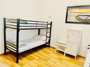 a bedroom with two bunk beds and a wooden floor at COMFORT INN ROMA TERMINI in Rome