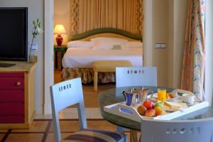 a hotel room with a tray of fruit on a table at Hotel Playa Victoria in Cádiz
