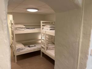 a room with three bunk beds in a room at Hostel Dalagatan in Stockholm