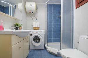 a bathroom with a washing machine and a shower at Only One in Ermoupoli