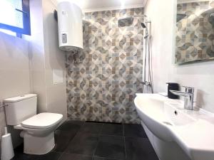 a bathroom with a toilet and a sink at Botabara 312 Self Catering Beach Apartment in Pomorie
