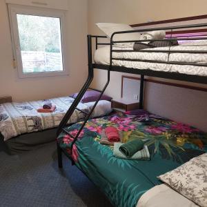 CaurelにあるCap'tain Cookの二段ベッド2台と窓が備わる客室です。