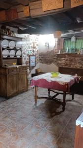 a kitchen with a table and a stone wall at MRZ rentals LA CASINA in Cudillero