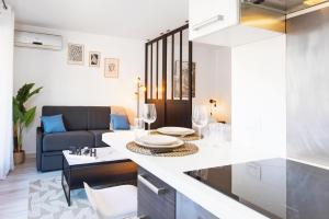 een woonkamer met een bank en een tafel bij 5 mn à pied Monaco - Cosy appartement in Beausoleil