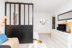 a living room with a black sliding door at 5 mn à pied Monaco - Cosy appartement - BU in Beausoleil +14 photos