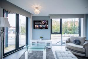 a living room with a couch and a table at New studio balcony apartment in Sheffield in Sheffield