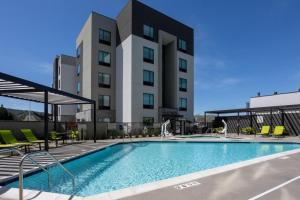a swimming pool in front of a building at TownePlace Suites by Marriott Pleasanton in Pleasanton