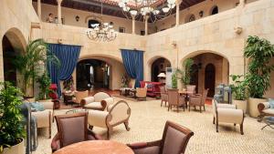 a lobby with chairs and tables in a building at Hotel Fortaleza do Guincho Relais & Châteaux in Cascais