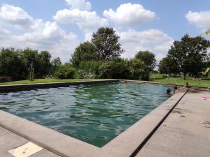 a swimming pool with people in the water at Bicoca - Casaletti in Viterbo