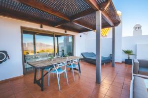 a dining room with a table and chairs at Penthouse La Cala De Mijas Golfview,Mountain ans Seaview in La Cala de Mijas