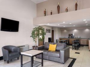 a living room with a couch and a table at Travelodge by Wyndham Tucson AZ in Tucson