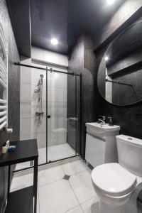 a bathroom with a shower and a toilet and a sink at New Gudauri View Hotel in Gudauri