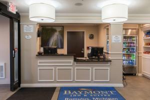 a cashiers counter in a store with two computers at Baymont by Wyndham Detroit Airport/Romulus in Romulus