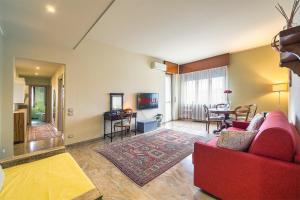 uma sala de estar com um sofá vermelho e uma mesa em Crystal Domus em Monza