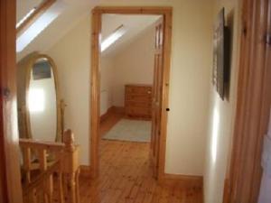 um quarto com um corredor com um espelho e uma escada em House Overlooking Ballinskelligs Bay em Waterville