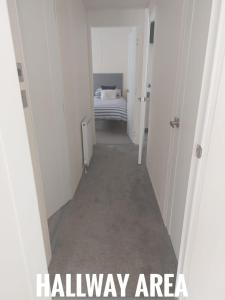 a hallway with a room with a bed in it at Greenshaw - extremely spacious in Rye Harbour