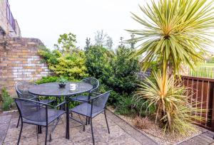 una mesa negra y sillas en un patio en GuestReady - Impressionante 2BR Flat com Vista Terraço e Mar en Malahide