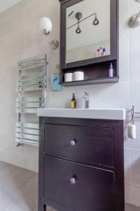 a bathroom with a sink and a mirror at GuestReady - Tranquil Retreat in Kimmage in Crumlin