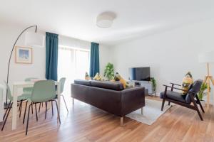 a living room with a couch and a table at GuestReady - Modern stay by Pheonix Park in Dublin