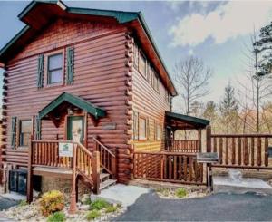 a log cabin with a porch and a deck at Dreams Come True With This Luxury Cabin! in Gatlinburg