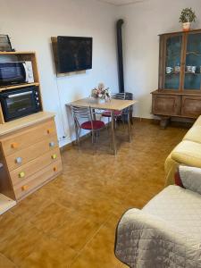 a living room with a table and chairs and a tv at Casa rural privada in Orihuela