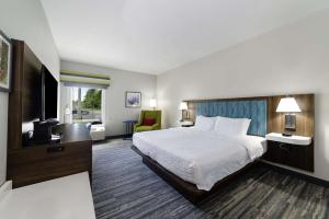 a hotel room with a bed and a television at Hampton Inn Port Charlotte in Port Charlotte