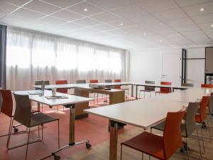 a conference room with tables and chairs and curtains at ibis budget Nice Californie Lenval in Nice