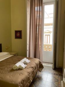 a bedroom with a bed with towels on it at Umberto House Catania in Catania
