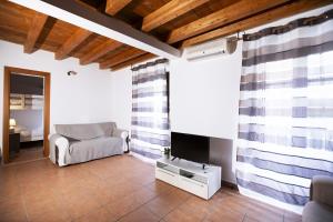 a living room with a couch and a television at Montesanto 13 in Palermo