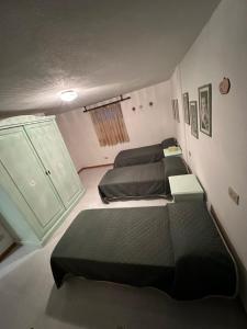 a room with three beds and a window at Comfort House in Olbia