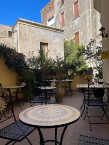 a patio with tables and chairs in a courtyard at Umberto House Catania in Catania