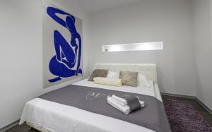 a bedroom with a bed with two towels on it at Luxury Villa M in Rogoznica +22 photos